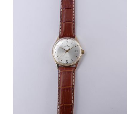 A Garrard 9ct gold automatic Wristwatch, the silvered dial with Arabic quarter numerals and baton markers with date aperture 