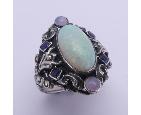 An Arts and Crafts silver Ring,&nbsp;in the manner of Bernard Instone, with central cabochon opal, approx. 14.5mm long, with 