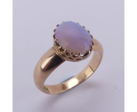 An oval opal Ring, the stone approx. 10mm long, claw set in 15ct gold, Size L, 4.2g.