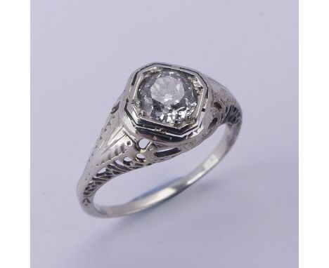 A single stone diamond Ring, the circular stone approx. 0.7ct, difficult to size within the mount, in an unmarked pierced whi