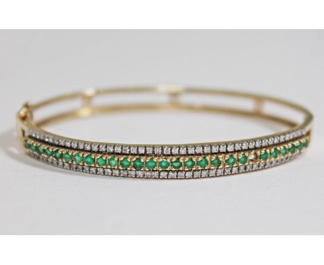 A hallmarked 9ct gold diamond emmerald bangle, diam. 6cm, gross wt. 13.6g.