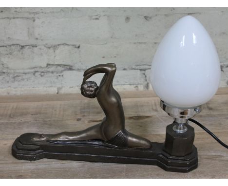 An Art Deco plaster figural lamp formed as a semi nude girl stretching, length 41cm.