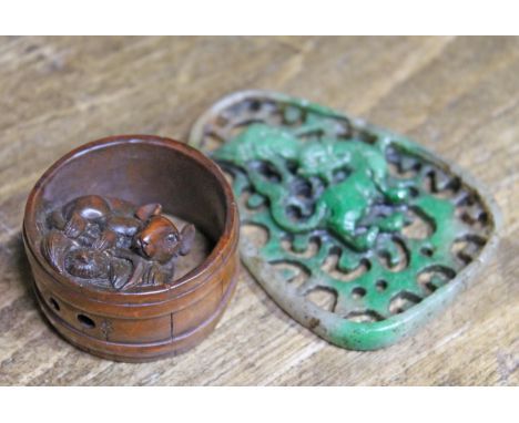 A Japanese hardwood Netsuke and a pierce jade pendant.