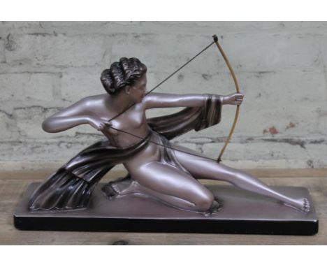 An Art Deco plaster figure formed as a semi nude girl firing a bow and arrow, length 54cm.