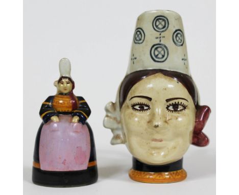 Two pieces of Quimper pottery comprising a bell formed as a lady and character jug, heights 11.5cm & 15.5cm. Condition - each