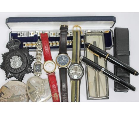 A mixed lot comprising four wristwatches (Rotary, Accurist, Casio & Swatch), a Police badge, three pens etc.