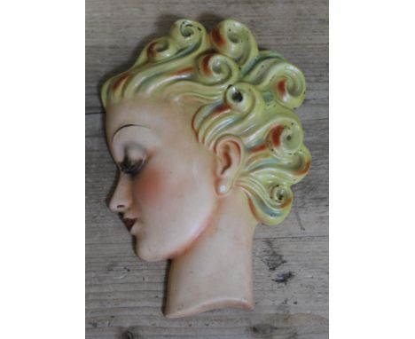 An Art Deco Goebel wall mask formed as a girl with curled hair in profile, designed by Agnes Richardson, circa 1930s, length 