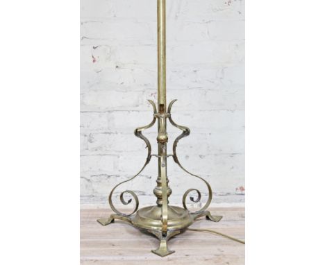 An Arts & Crafts style adjustable brass lamp standard.