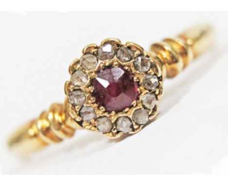 A 1920s hallmarked 18ct gold diamond and ruby cluster ring, the daisy head approx. diam. 7mm, gross wt. 3.3g, size Q.