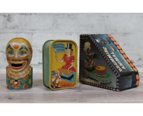 A J Chein clown money box, a Codeg Magic money box and a tinplate toy.