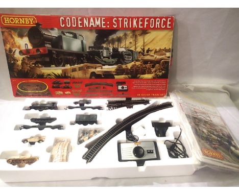 Hornby OO scale train set, R1147 codename Strikeforce, comprising of 0.4.0 tank locomotive camouflage green, plus two lowmac,