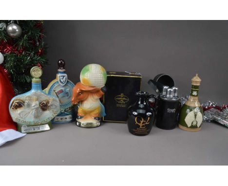 A boxed bottle of QE2 Highland Malt Scoth Whisky in ceramic decanter and four ceramic empty novelty decanters, including a Co