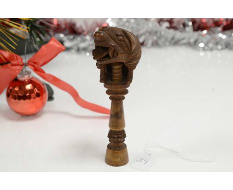 A late 19th or early 20th century Black Forest wooden nut cracker, modelled as a Chinese dog of Fu, chipped to both ears, Pro