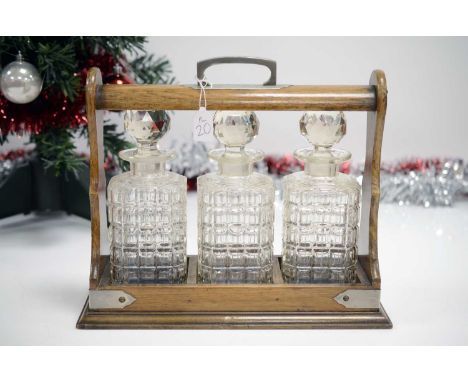 An Edwardian period and later tantalis, perfect to lock away your Christmas tipples, oak locking case with three later moulde