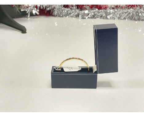 A modern and very pretty 18ct gold bangle set with diamonds and rubies, 17g, inner 60.8mm, outer 63.6mm, marked 750, one half