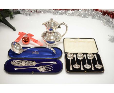 A small group of silver plated items, including a large kings pattern soup ladle, a teapot, a posh cased pair of fish servers