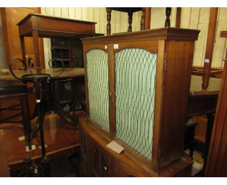 19th Century mahogany wall cabinet, the moulded top above two brass grilled doors with green silk pleat enclosing a single sh