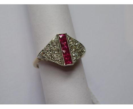 Yellow gold Art Deco style ring set a row of four rubies flanked by twelve brilliant cut diamonds 