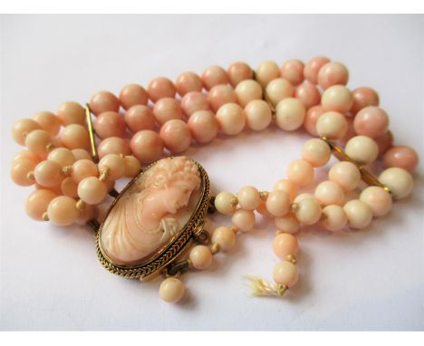 Victorian triple row angel skin coral bead bracelet, the oval clasp inset with carved cameo angel skin portrait (one row deta