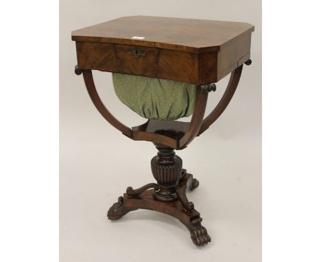 Regency mahogany work table, the concave front with a hinged lid enclosing a fitted interior above a wool bag on a baluster f