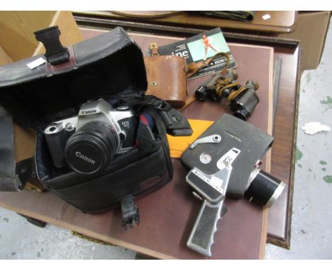 Canon EOS 500 35mm camera, a Bell & Howell cine camera and a pair of small Zeiss binoculars 