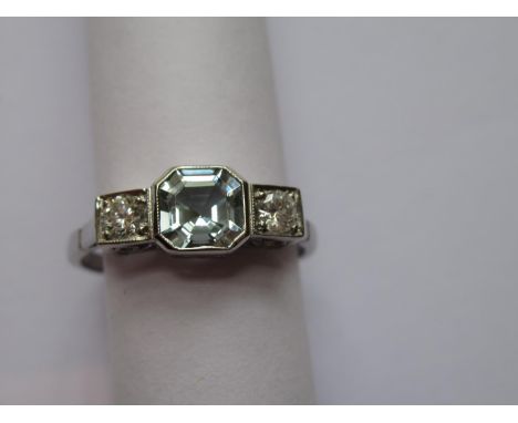 Platinum ring set octagonal aquamarine flanked by two brilliant cut diamonds 