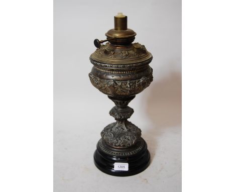 Victorian patinated metal oil lamp on a black pottery base (minus shade) 