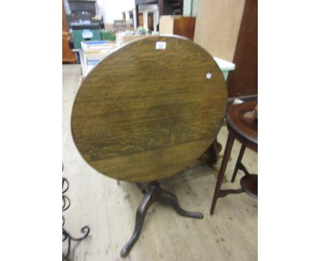 Good quality reproduction oak circular pedestal table, the tilt top above a baluster column support and tripod base 