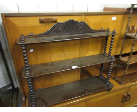 Rosewood three tier wall bracket having carved surmount and bobbin turned supports, 26ins high x 31ins wide x 8ins deep 