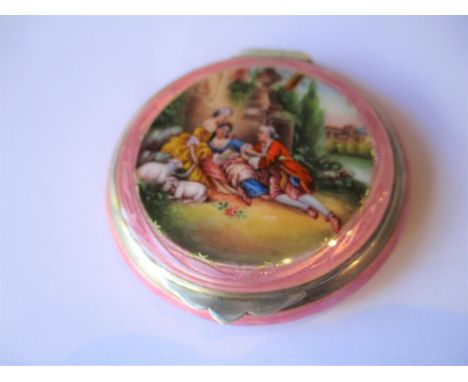 Continental 925 silver and pink enamel compact, the cover decorated with figures in a landscape (at fault). 2.25ins diameter 