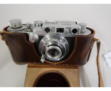 Leica 35mm camera, numbered 230167, with lens and original leather case with strapAppears to be in good condition relative to