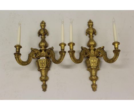 Pair of 19th Century carved and gilded composition twin light wall sconces of faceted baluster form, 24ins high (repairs and 