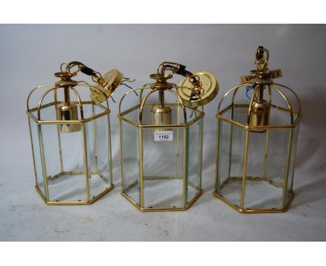 Set of three modern gilt brass hexagonal lantern form light fittings, 12ins high excluding chain fittings and ceiling roses 