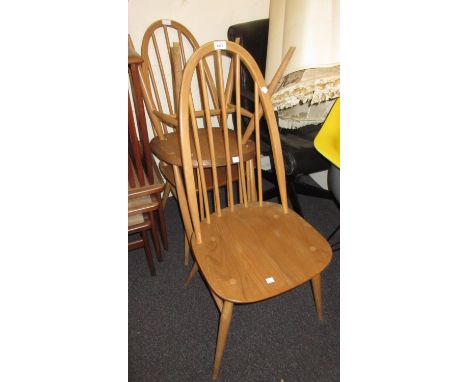 Set of three Ercol elm and beech hoop and stick back dining chairs with panel seats on tapering supports 