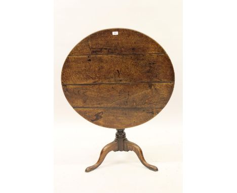 18th Century oak pedestal table, the circular tilt top on a baluster turned support and tripod base. 34ins diameter x 28ins h