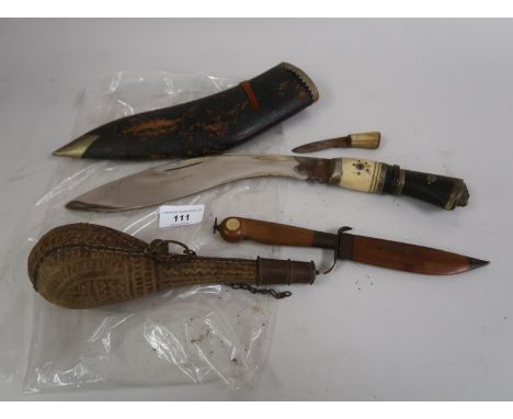 Bone and horn handled kukri with leather scabbard (lacking one blade), small wooden handled knife and a shot flask 