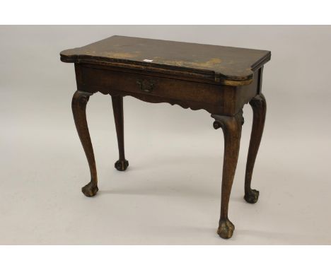 Early George III mahogany fold-over card table, the shaped baize lined fold-over top above a single drawer, raised on carved 