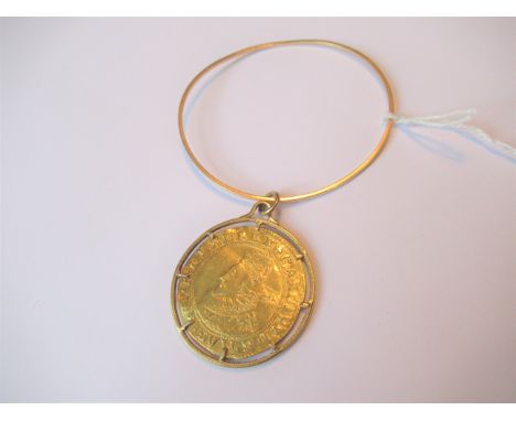 Charles I gold Unite in a modern yellow metal mount attached to a yellow metal bangle 