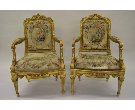Pair of 19th Century French giltwood open armchairs, the floral and acanthus decorated frames with padded backs and overstuff