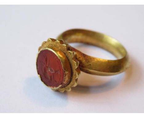 Roman high carat gold ring inset with a cornelian intaglio depicting a centaur, 7g (with accompanying provinence) 