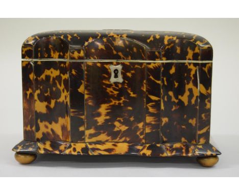 19th Century tortoiseshell serpentine shaped two division tea caddy, raised on low bun feet, 7.75ins x 5ins x 5ins high (some