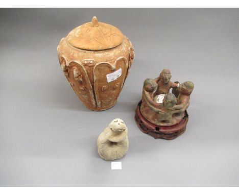 Pre-Columbian style figural candlestick together with a pottery vase and cover, 8ins high and a pottery figure of a snake, in