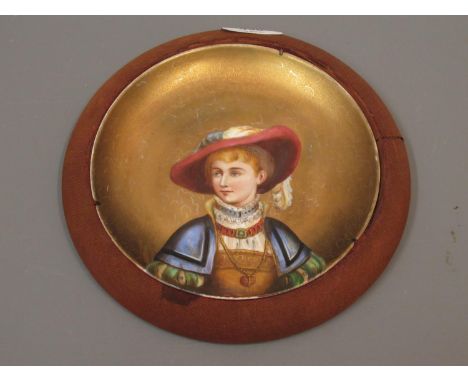 Late 19th Century Continental plate painted with a head and shoulder portrait of a figure with gilt background and cloth cove