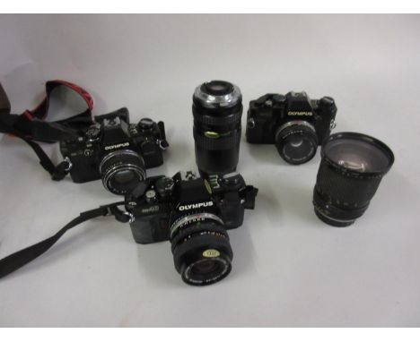 Olympus OM40 35mm camera, another similar camera, an Olympus OM10 35mm camera and various lenses in two cases 