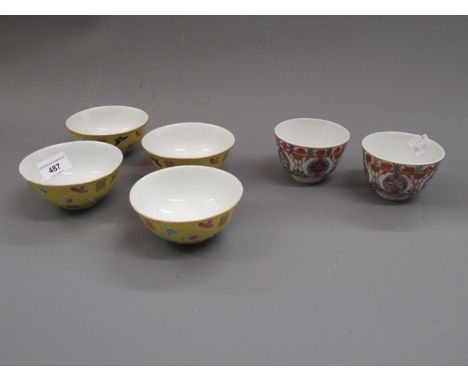 Set of four Chinese rice bowls decorated with butterflies and moths on a yellow ground , signed with four character mark to b