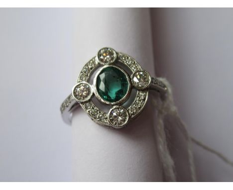 Platinum oval emerald and diamond cluster ring 