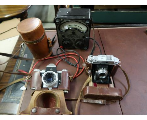 Early Praktica SLR camera, another leather cased camera, leather cased glass and chrome three bottle travel set and a Univers