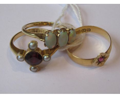 18ct Gold cruciform ring set garnet and four seed pearls, together with a 9ct gold three stone opal ring and a 22ct gold ruby