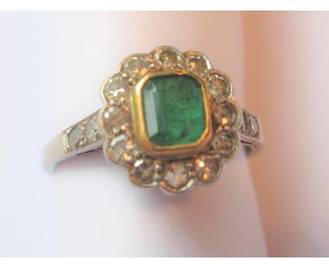 Platinum emerald and diamond set dress ring, the emerald approximately 5mm x 4mm 