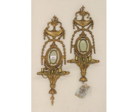 Pair of 19th Century carved and gilded composition twin light wall sconces of Adam style, each with a vase, swag and oval mir